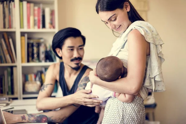 Father and mother taking care of child — Stock Photo, Image