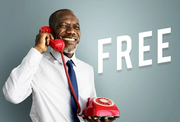 Business man using red telephone — Stock Photo, Image