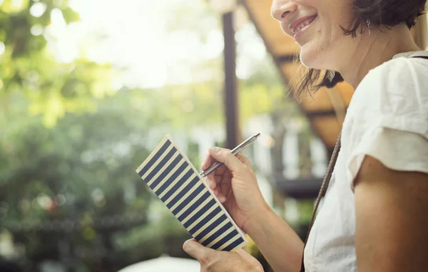 Woman writing in dairy — Stock Photo, Image