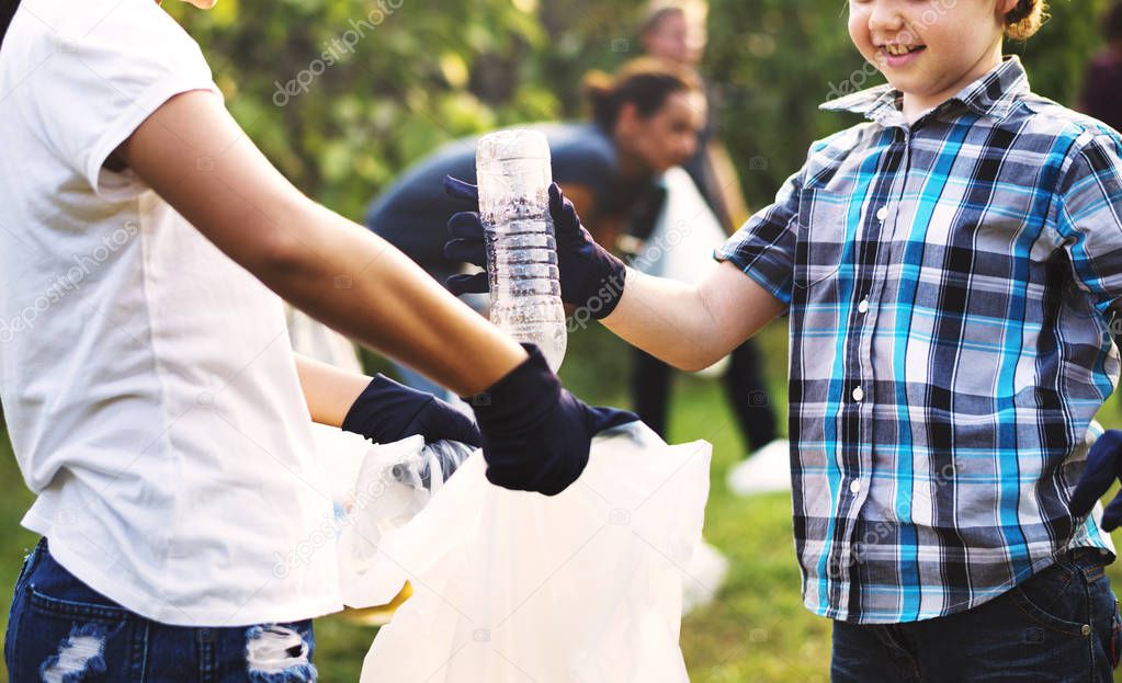 Boy Picking Up Plastic Bottle