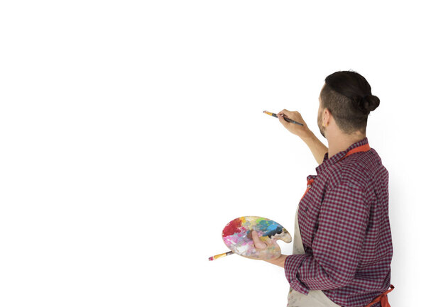man drawing on blank wall