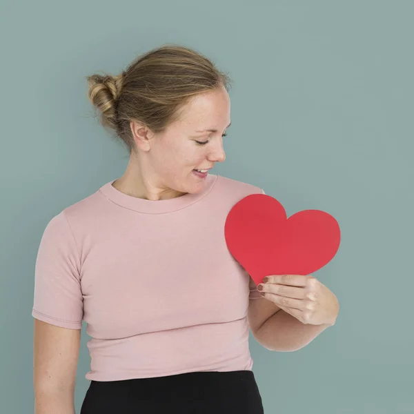 Woman looking at paper heart — Stock Photo, Image