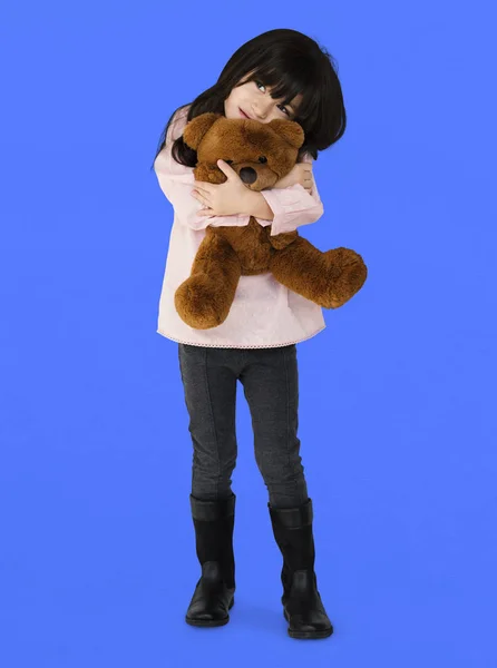 Meisje knuffelen teddybeer — Stockfoto