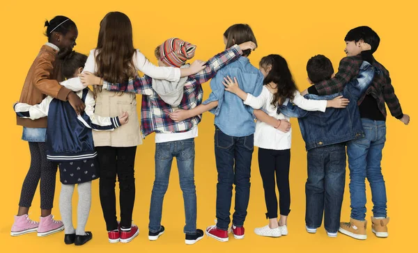 Diversity children hugging in studio — Stock Photo, Image