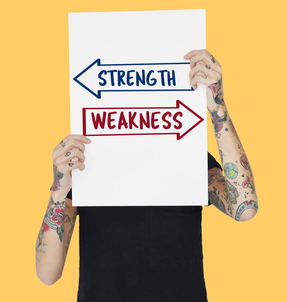 Tattooed person holding banner. 