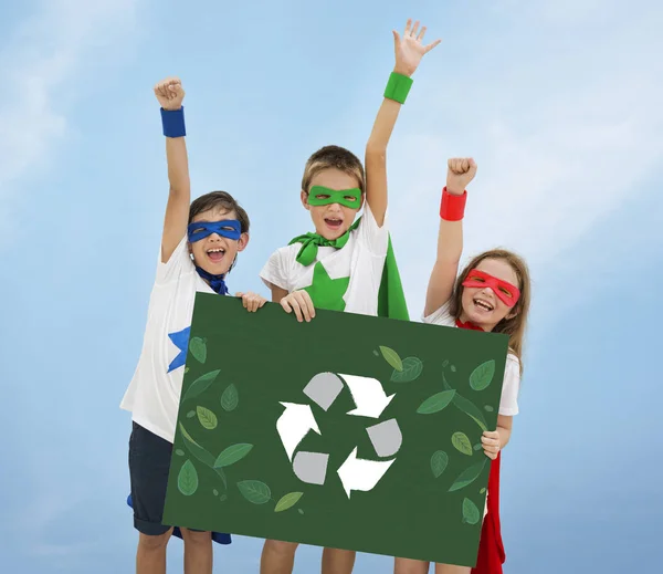 Superheroes kids holding poster — Stock Photo, Image