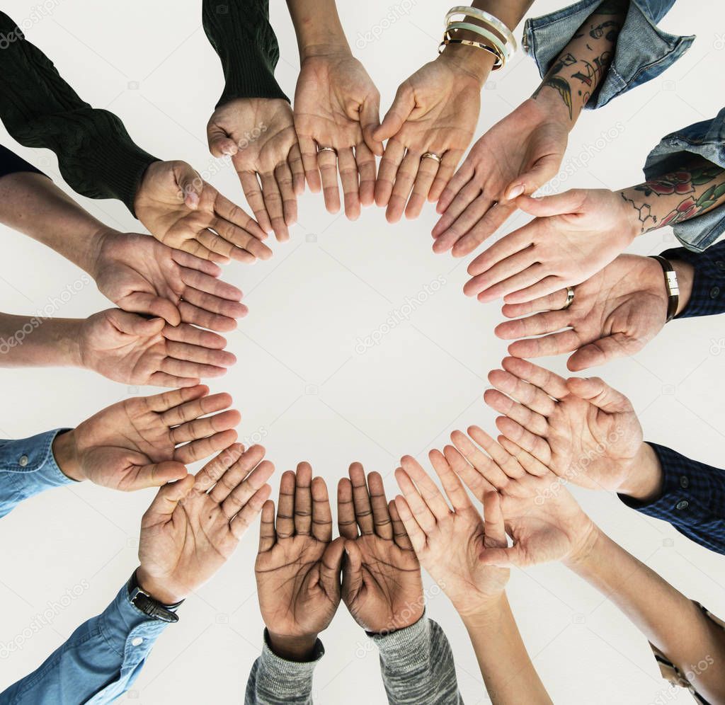 group of people holding hands in circle