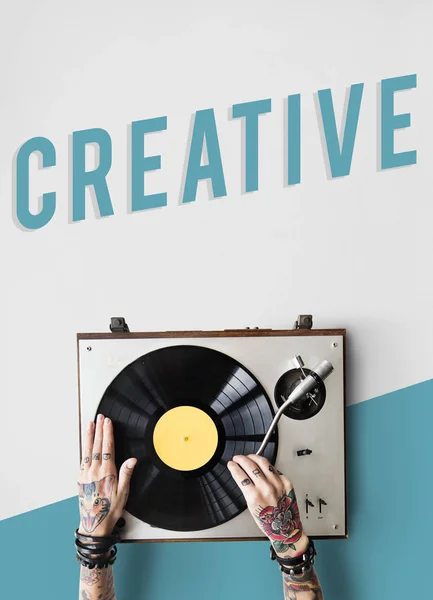 Tattooed person with vinyl player. — Stock Photo, Image