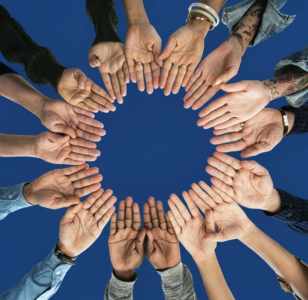 Group of people holding hands in circle — Stock Photo, Image