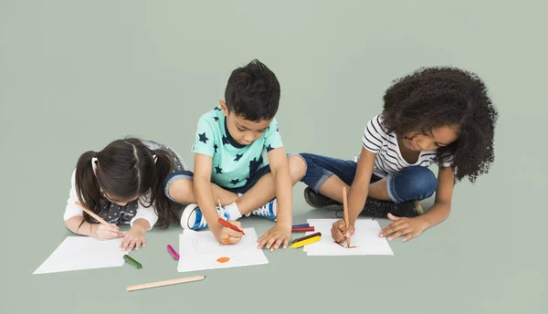 Діти сидять на підлозі і малюють — стокове фото