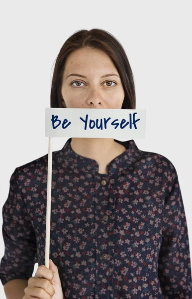 Woman covering mouth with paper flag — Stock Photo, Image