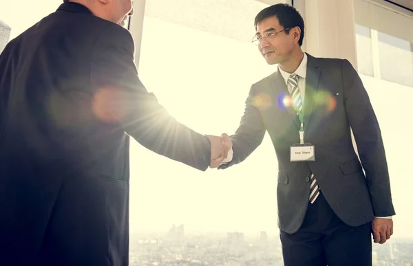 Asian men shaking hands — Stock Photo, Image