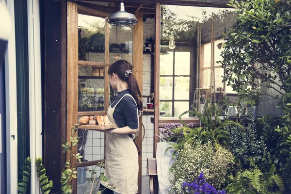 Woman carrying bread pastry to customer — Stock Photo, Image