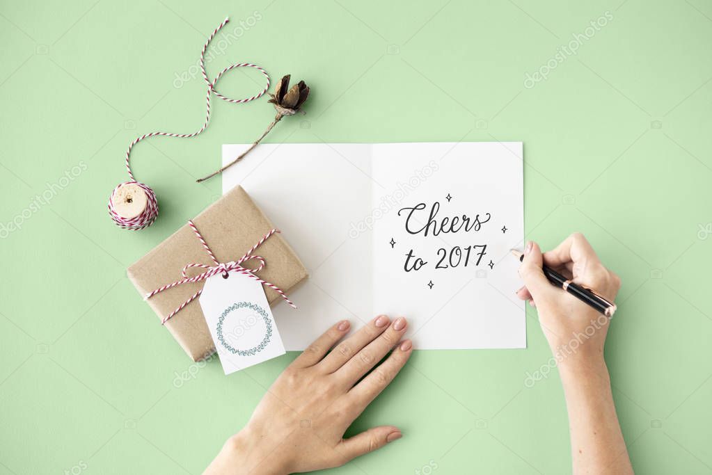 Person writing on greeting card