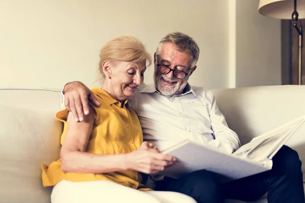 Couple Looking at Photo Album — Stock Photo, Image