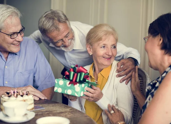 Senior woman receiving birthday present — Stock Photo, Image