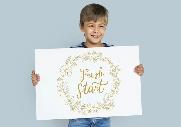 Boy holding placard — Stock Photo, Image