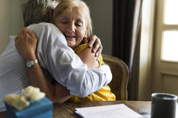 Senior couple embracing indoors — Stock Photo, Image