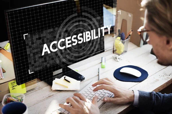 Man sitting against computer — Stock Photo, Image