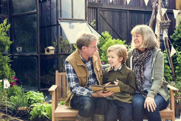 Grandparents Teaching Grandson Reading Book — Stock Photo, Image