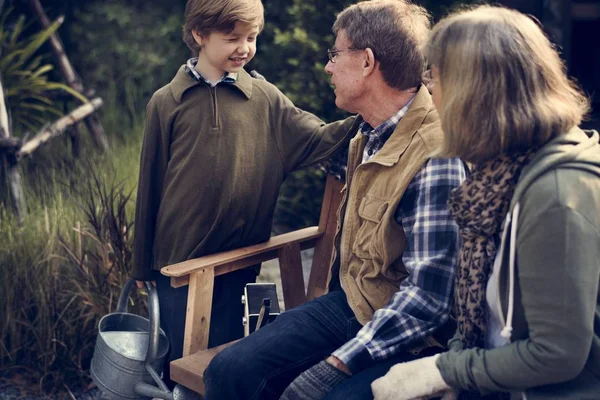 Senior couple and grandson at garden — Stock Photo, Image