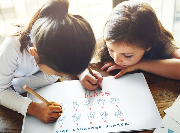 Girls drawing in sign language instruction — Stock Photo, Image