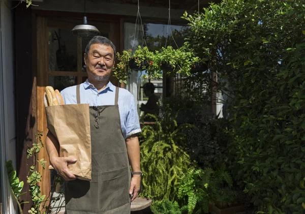 man holding Baguettes