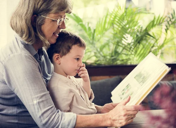 Grandmother and grandson reading book — Stock Photo, Image