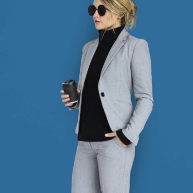 İş kadını elinde kahve kupası tutuyor.