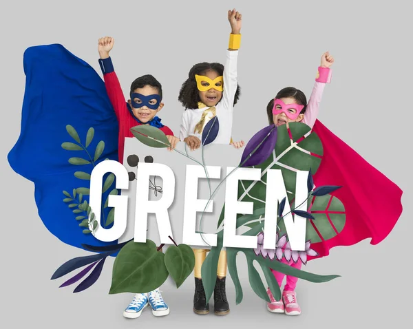 Kids in superhero costumes holding banner — Stock Photo, Image