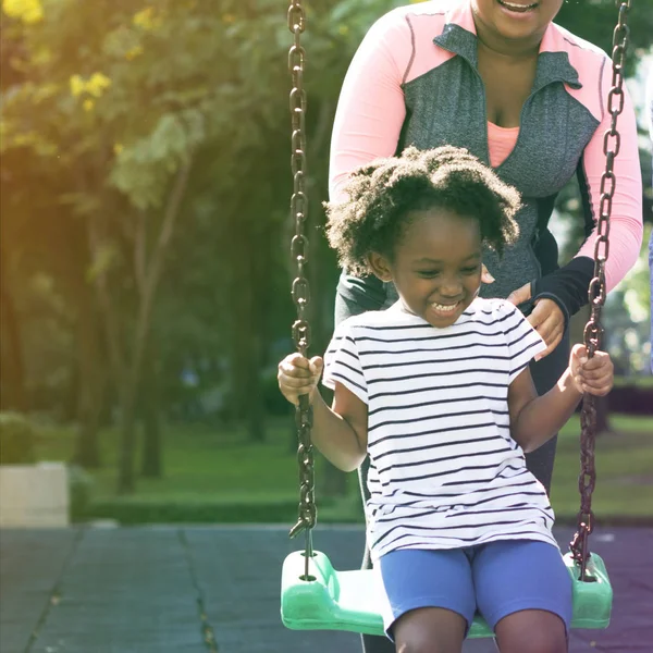 Girl swinging on swing — Stock Photo, Image