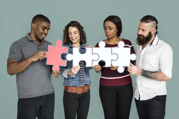 People holding puzzle pieces