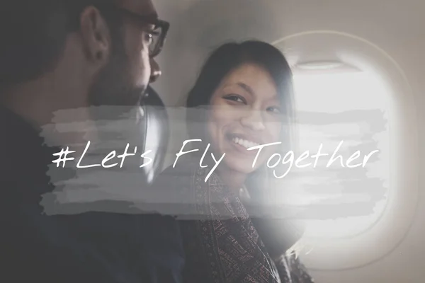 Man and woman in front of airplane porthole — Stock Photo, Image