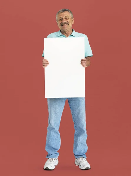 Senior man holding blank banner — Stock Photo, Image