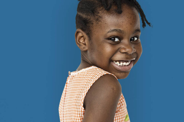 African little girl turn back and smiling, studio portrait
