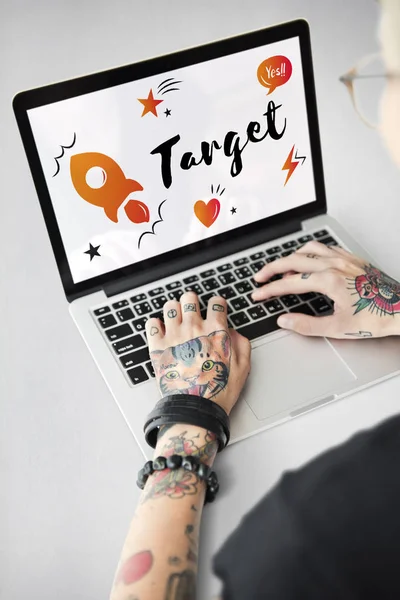 Tattooed person typing on laptop — Stock Photo, Image