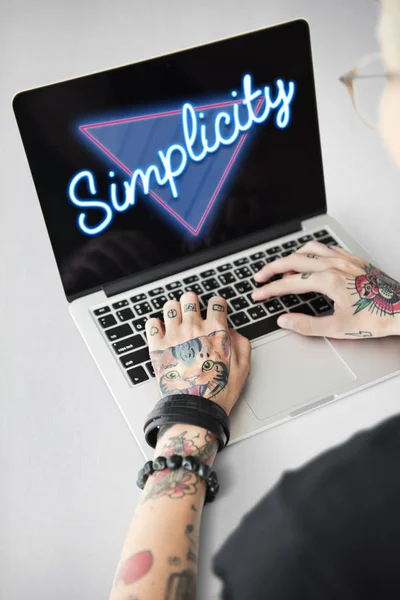 Татуированный человек на ноутбуке — стоковое фото