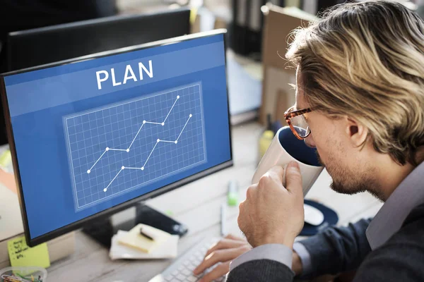 Man sitting against computer — Stock Photo, Image