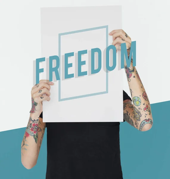 Tattooed person holding banner. — Stock Photo, Image