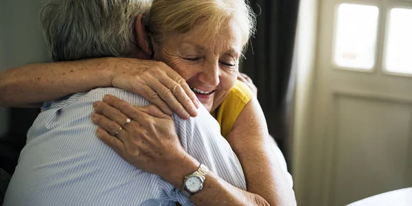 Äldre par embracing inomhus — Stockfoto