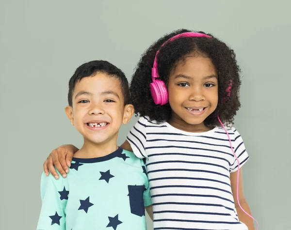 Boy hugging with girl in headphones — Stock Photo, Image