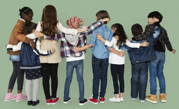 Children hugging in studio — Stock Photo, Image