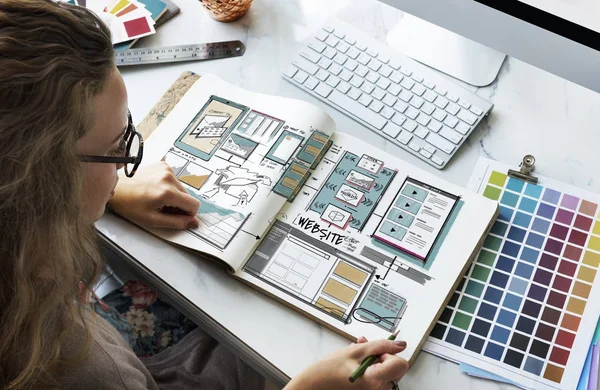 Designer drawing in album — Stock Photo, Image