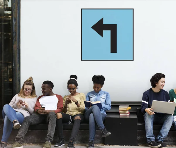 Young students siting near placard — Stock Photo, Image