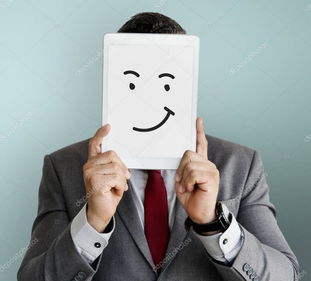 business man covering face with digital tablet 