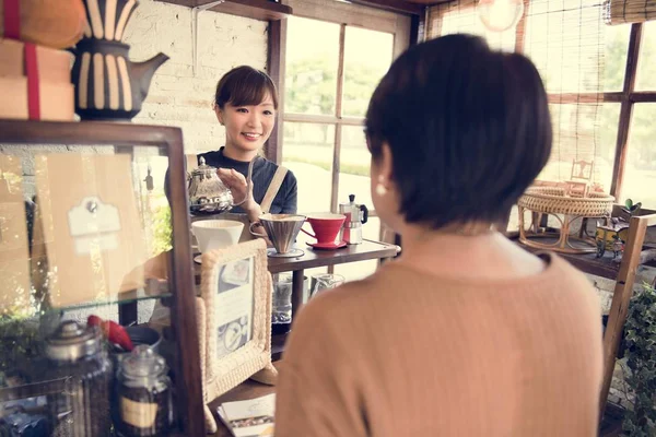 Camarera vertiendo té en la taza — Foto de Stock