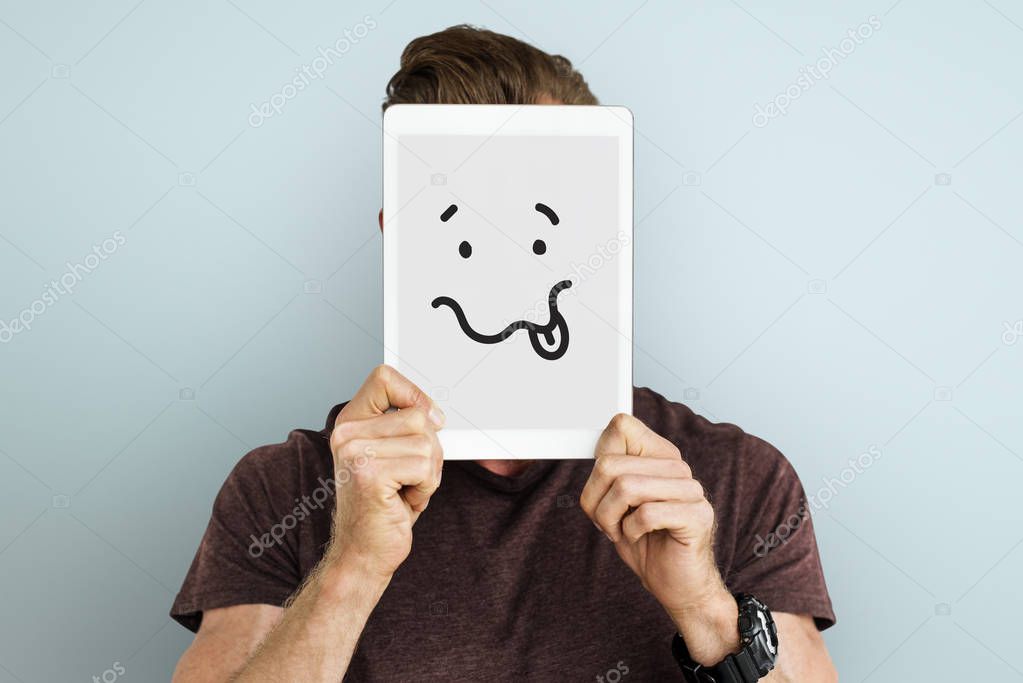 man holding digital tablet covering face 