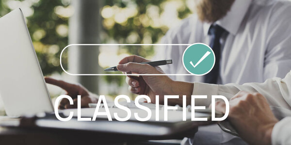 people brainstorming at table with laptop