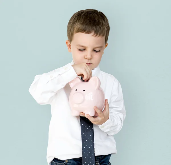 Chico holding piggybank —  Fotos de Stock