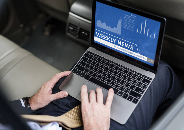 Businessperson using laptop in car